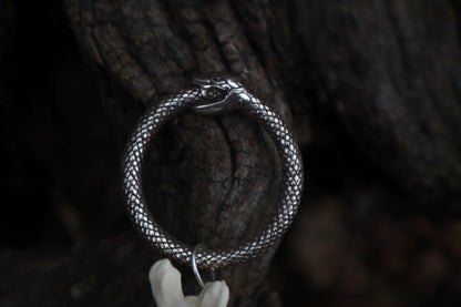 Fluid Gray Wolf Tail Articulation with Ouroboros Ring